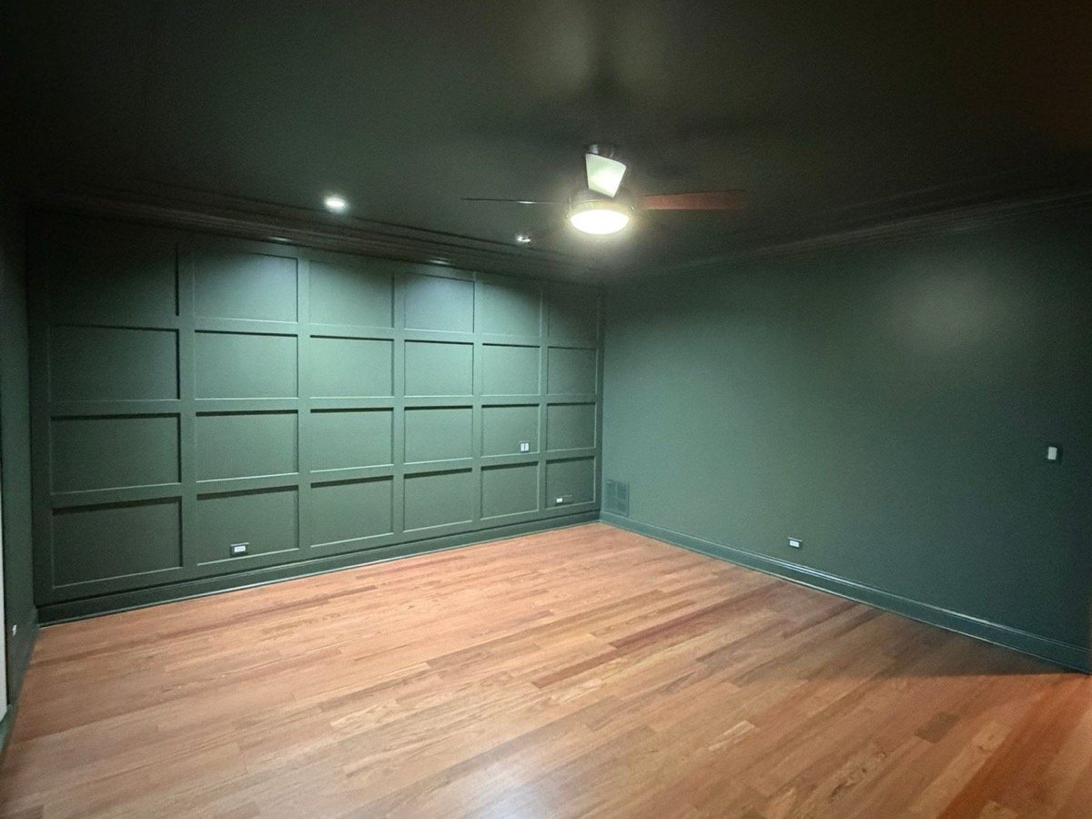Color-drenched master bedroom with panel molding