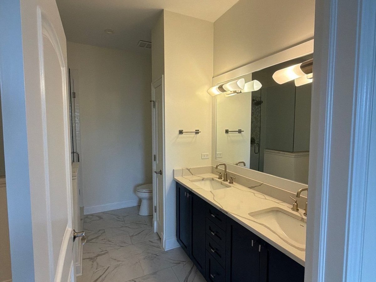 Bathroom walls and ceiling repainted around a navy vanity