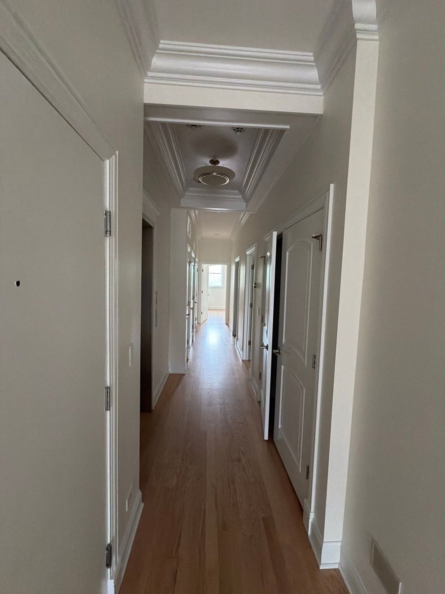 Finished hallway with six-panel doors painted in ProClassic semi-gloss