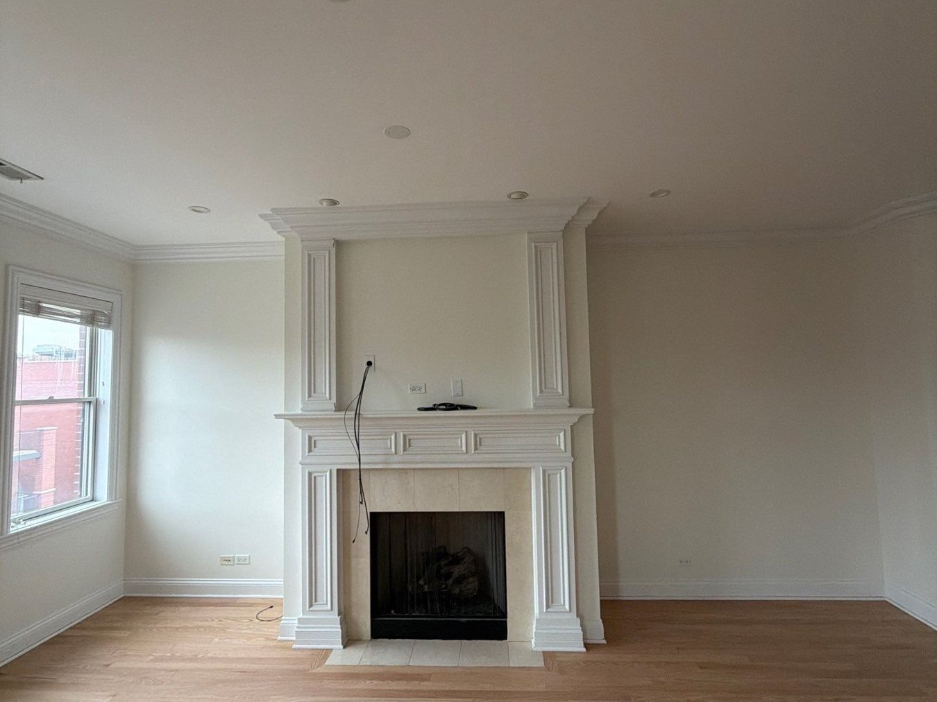 Wide view of the repainted living room and oak floors