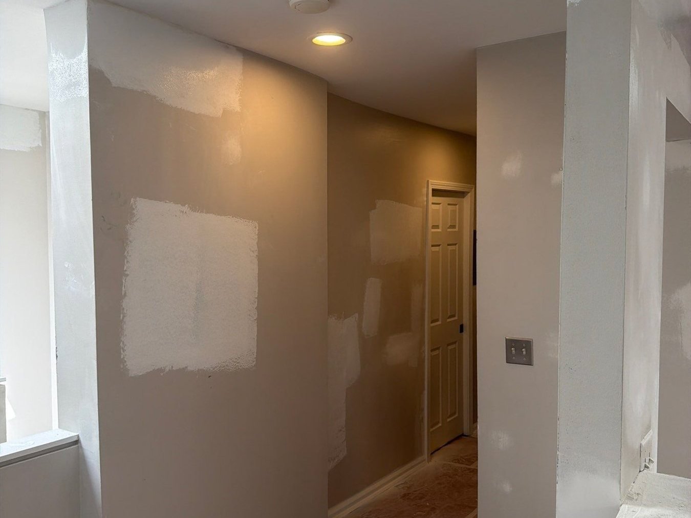 Lincoln Park living room before painting, walls patched and protected