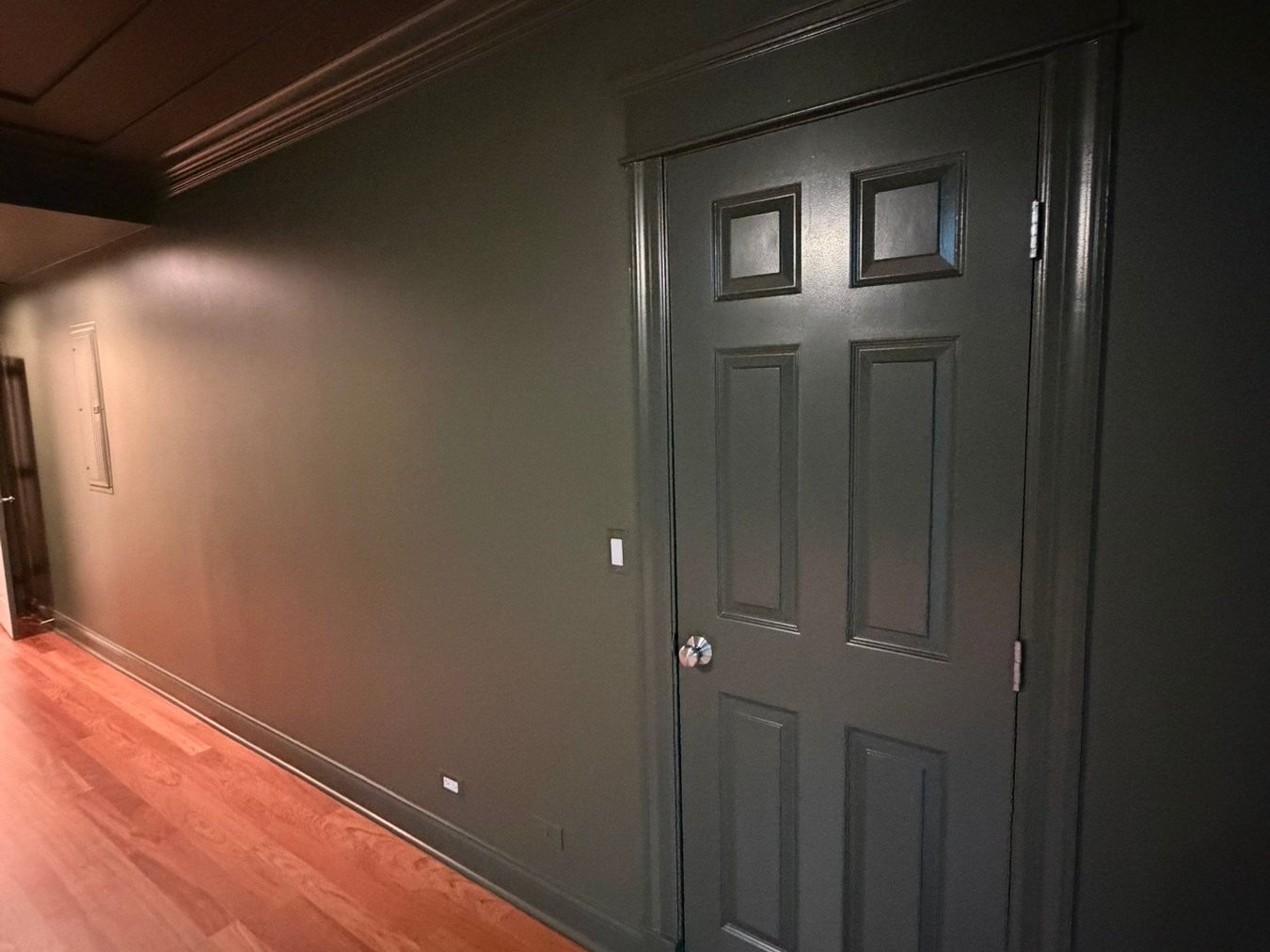 Master suite door and crown molding painted in deep green satin
